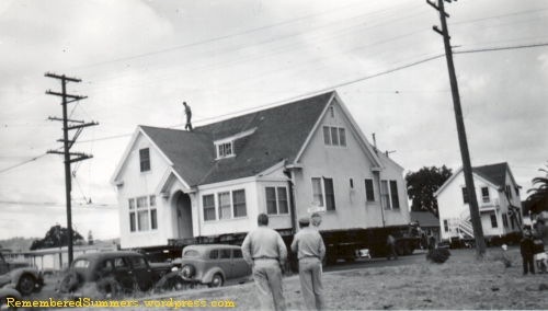 Two two-story houses being moved to a new location. About 1950. 